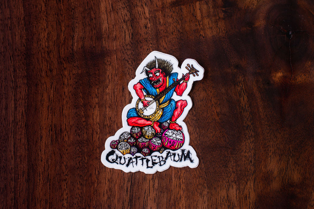 Quattlebaum Banjo Demon on a pile of Darumas Sticker