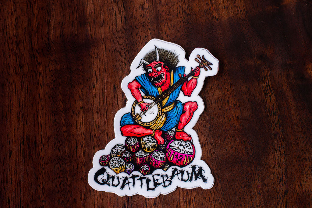 Quattlebaum Banjo Demon on a pile of Darumas Sticker